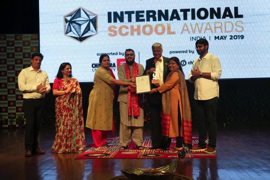 Pushpavalli receiving recognition at the International School Awards in 2019.