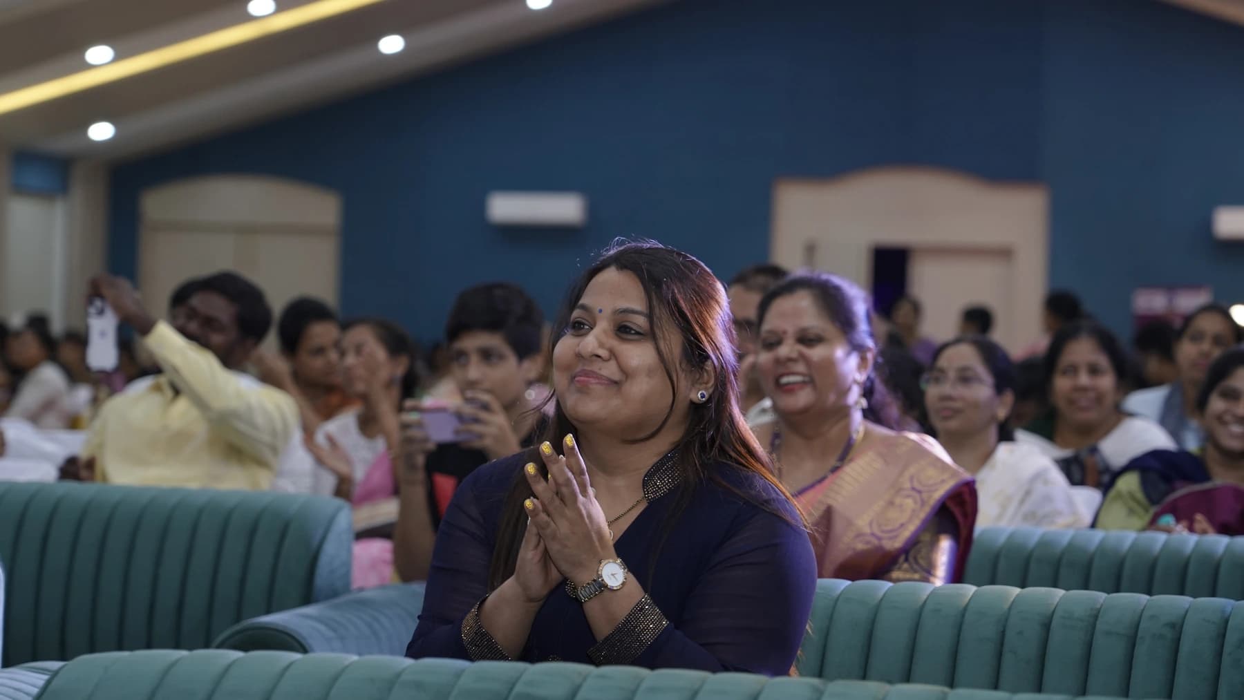 Pushpavalli listening at an education event.