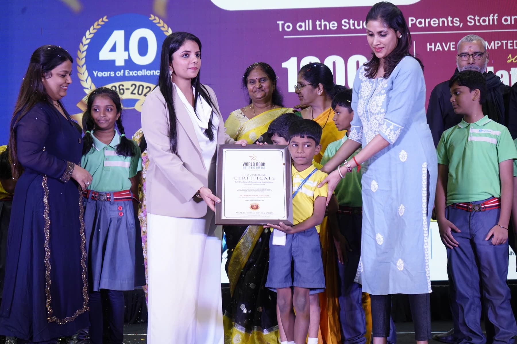 Pushpavalli with children and educators at a World Book of Records certificate presentation.