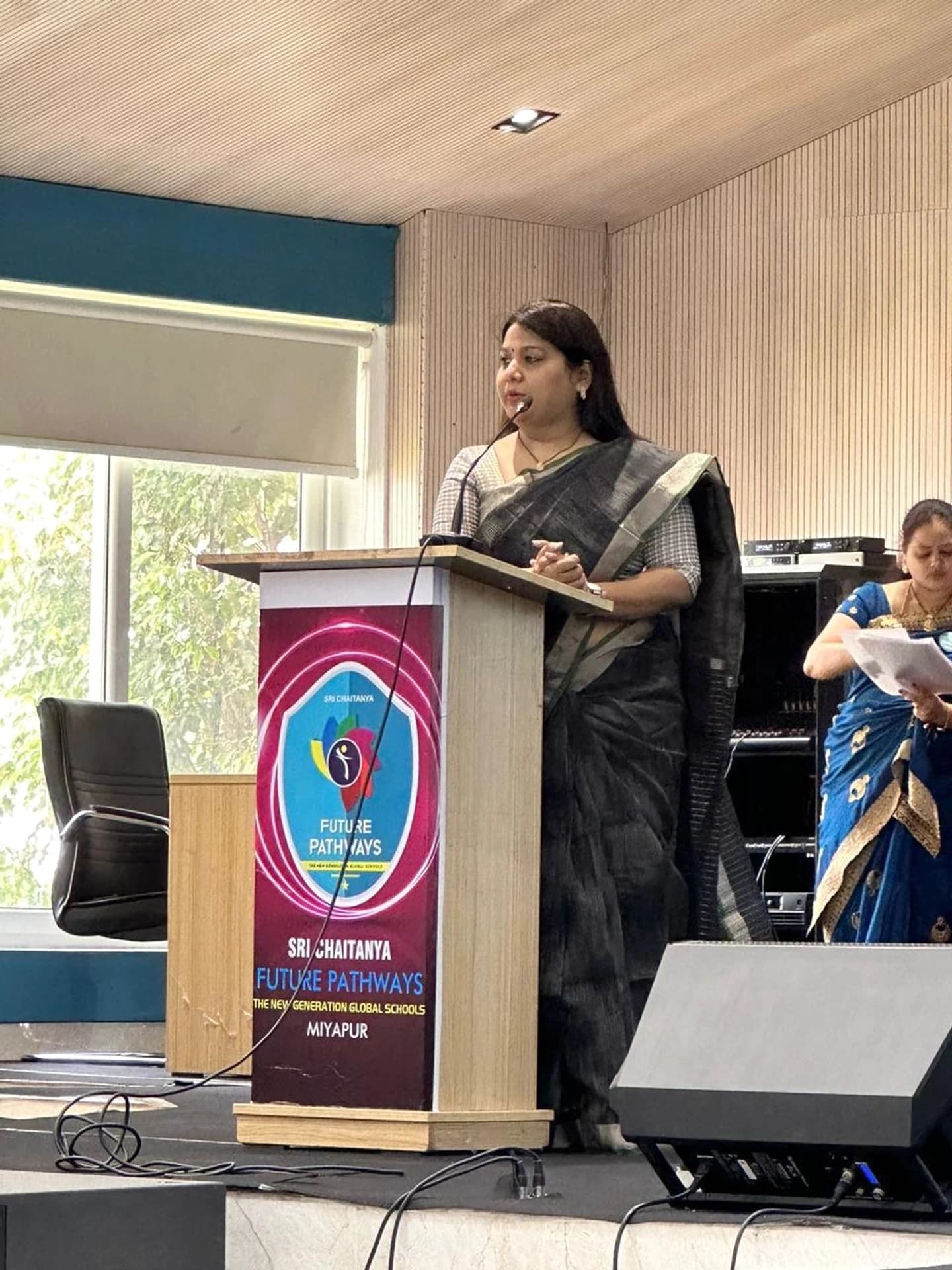 Pushpavalli addressing an audience from the Future Pathways podium.