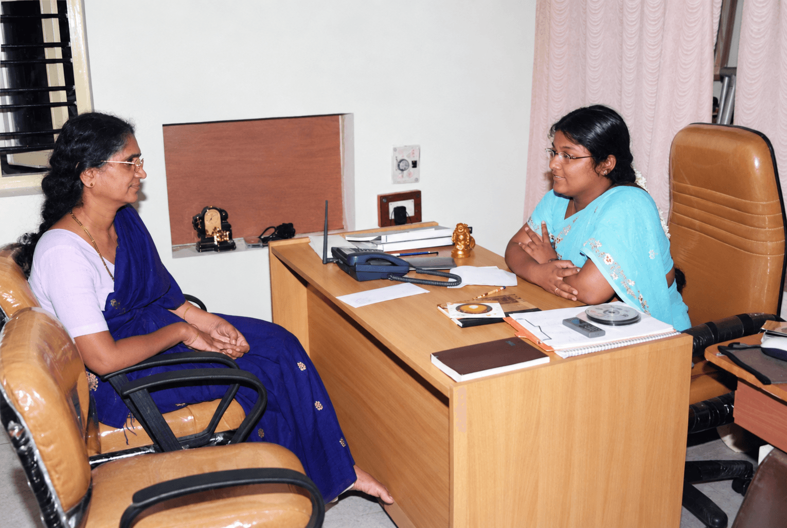 Pushpavalli in conversation with a visitor at the Prapoorna Children’s Club office.