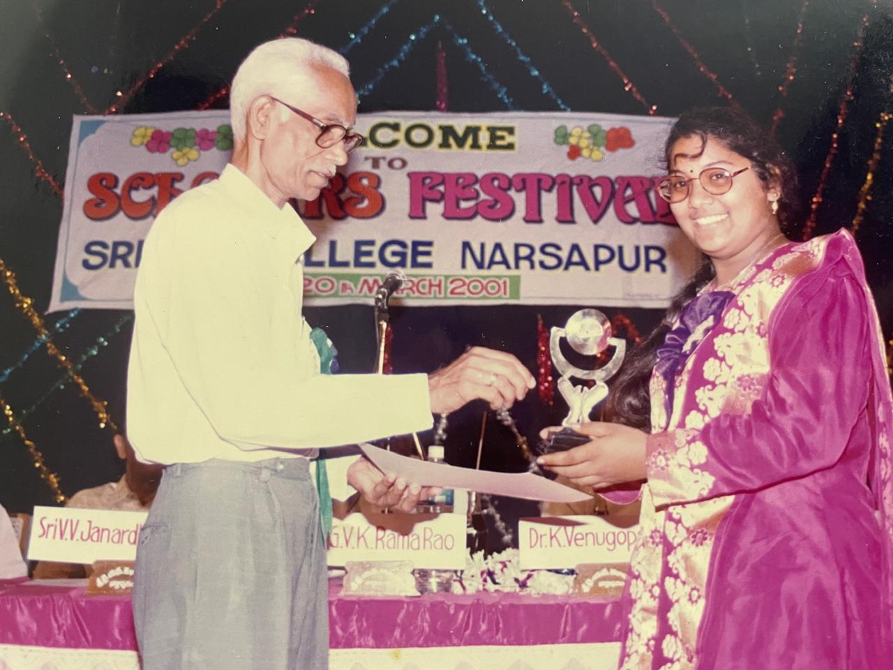 Pushpavalli receiving an award at a college scholars festival in Narsapur in 2001.